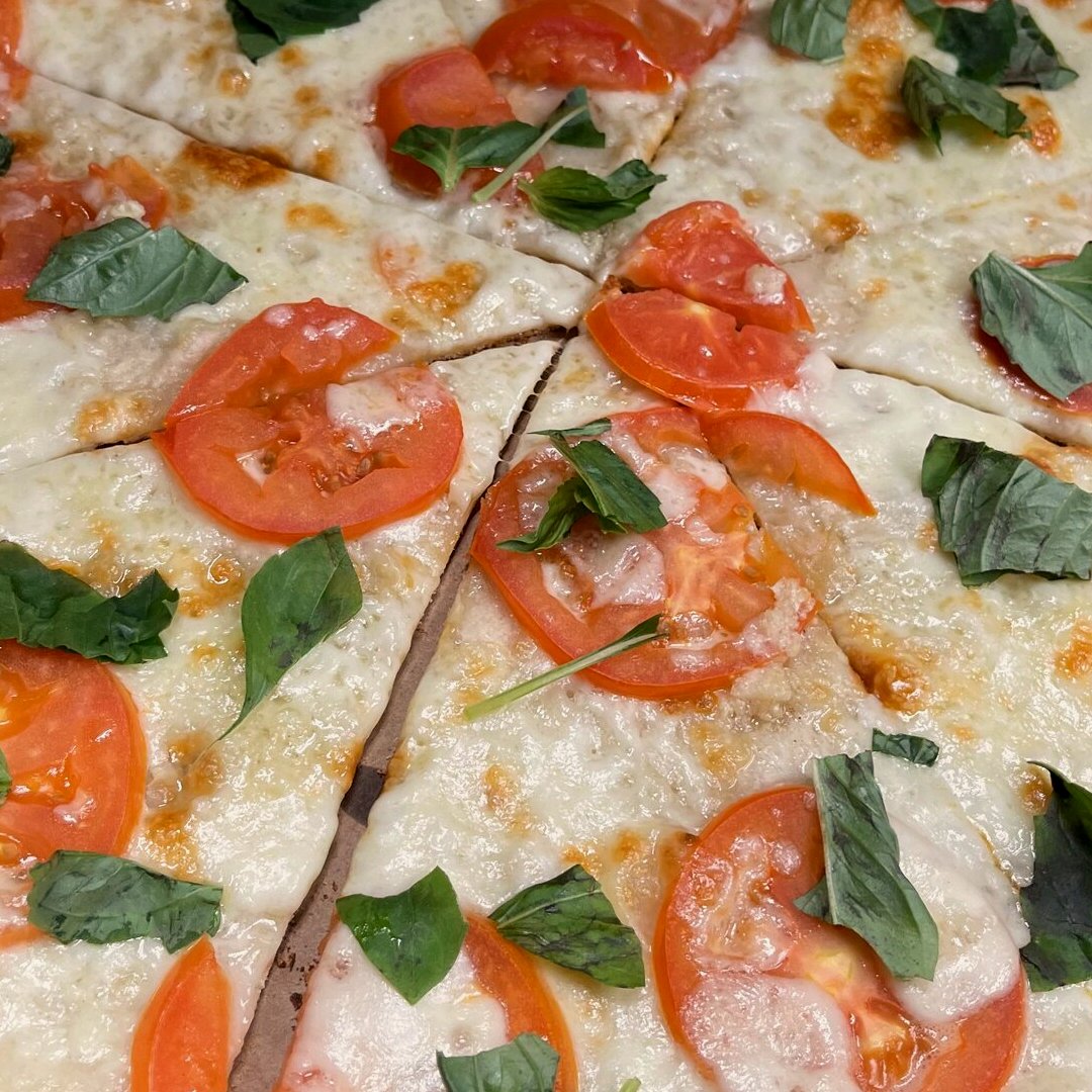 Margherita pizza — fresh mozzarella, tomato, basil at SOLO